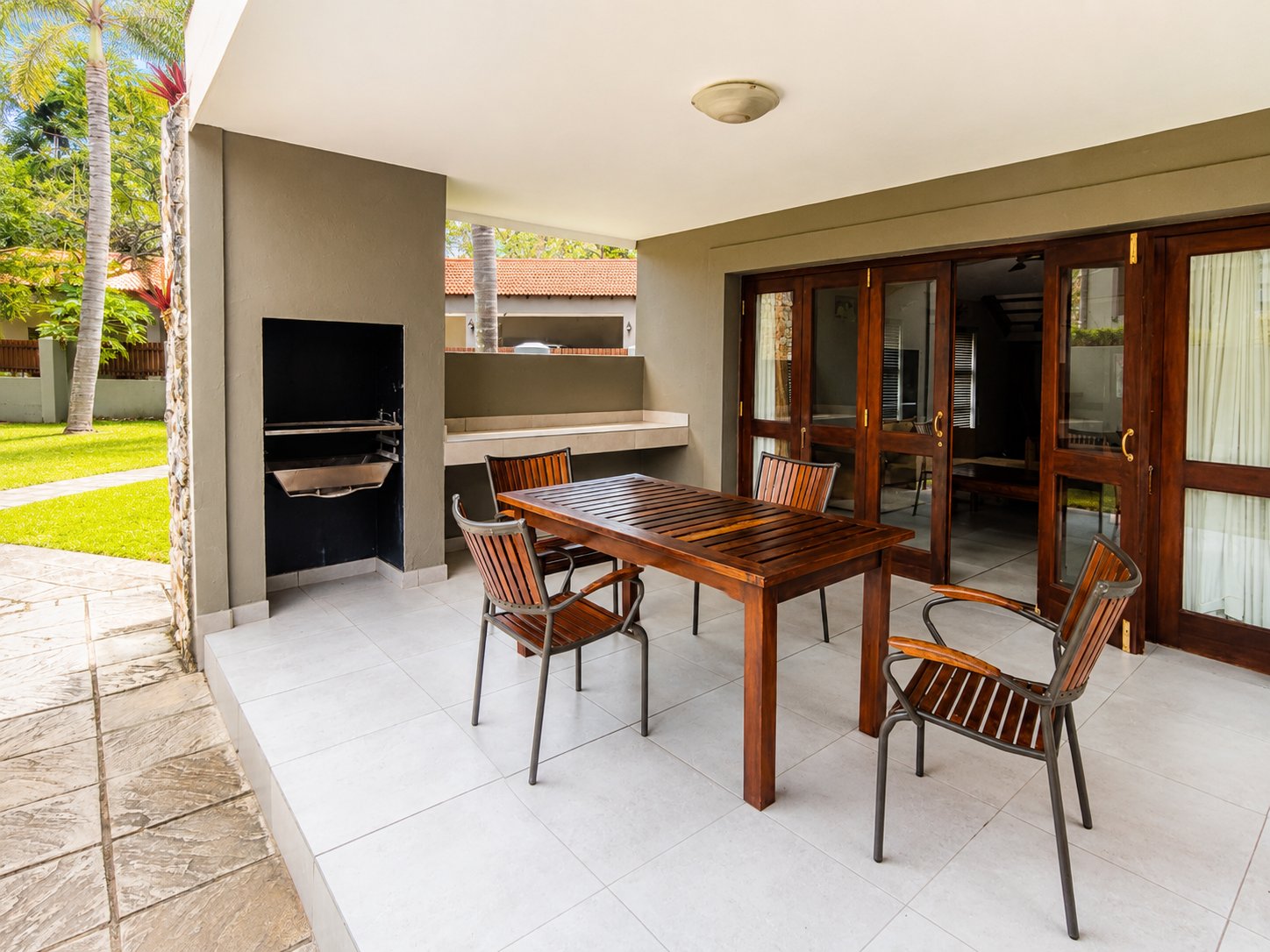 Covered patio with built-in braai and outdoor dining