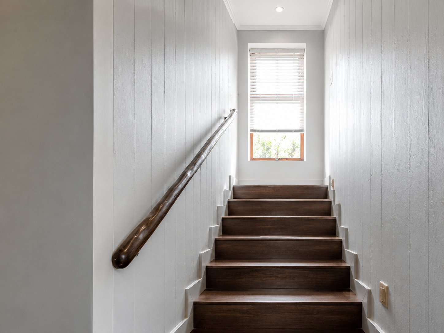 Wood-panelled staircase with window light