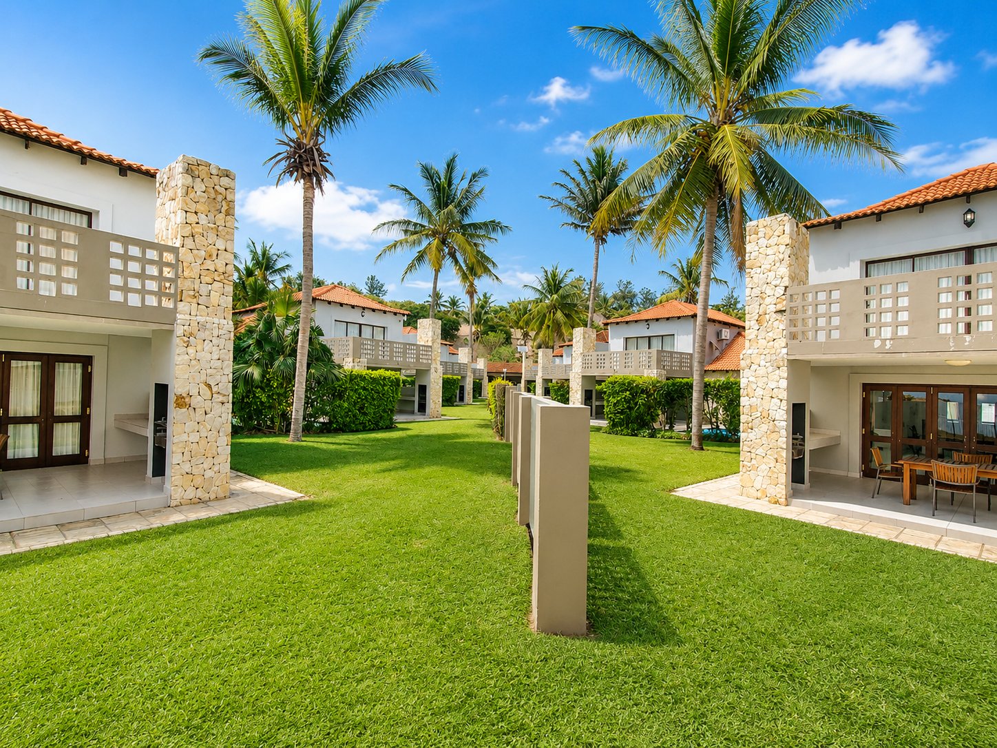 Pathway between units lined with palm trees