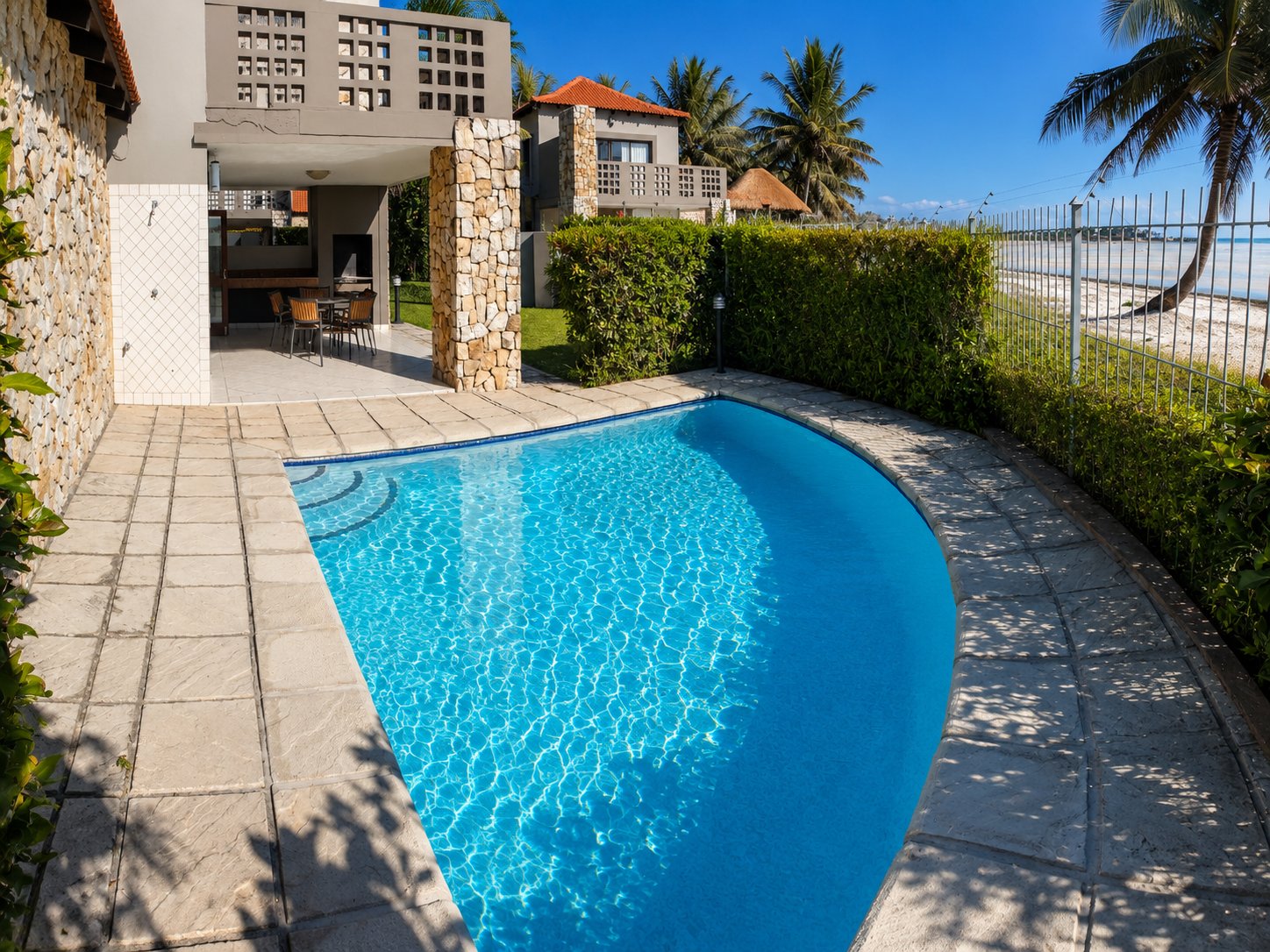 Poolside view with beach house neighbours
