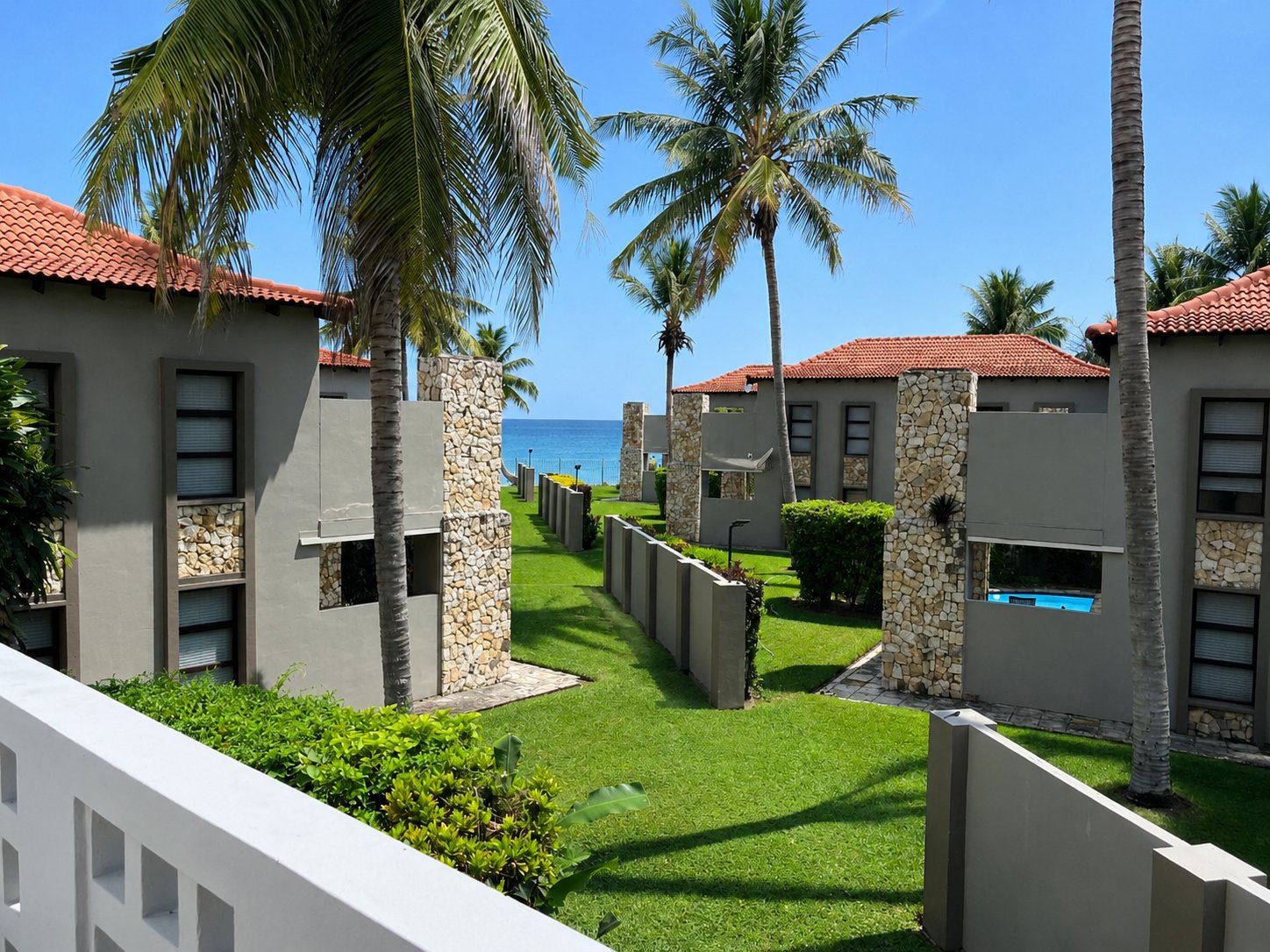 Ocean view from a unit balcony over the estate gardens